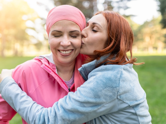 Two women embracing.