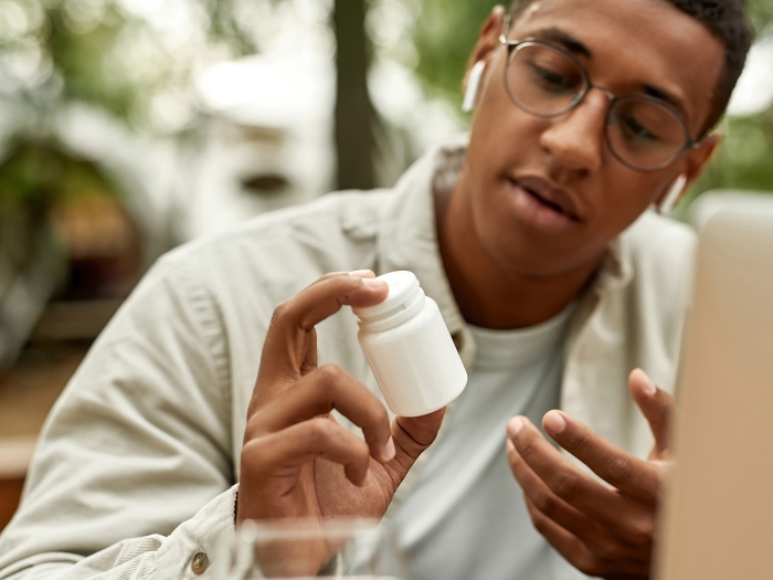 Patient looking at medication.